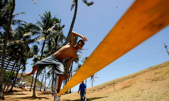 salvador, bahia / brazil  - november 4, 2015: Young man is seen practicing slegline in the Barra neighborhood in Salvador.