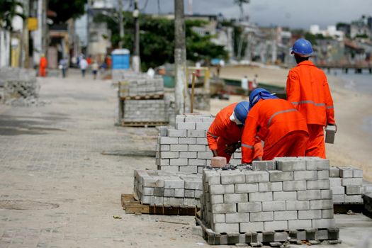 salvador, bahia / brazil - july 23, 2015: Workers are seen working on recovery works on Avenida Beira Mar in the Ribeira neighborhood in the city of Salvador.


