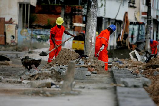 salvador, bahia / brazil - july 23, 2015: Workers are seen working on refurbishment works of Beira Mar Avenue in the Ribeira neighborhood of Salvador.

