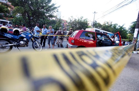 salvador, bahia, brazil - october 15, 2015: Agents from the homicide police station and experts carry out an investigation in the place where a man was murdered in the city of Salvador.