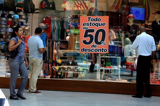 salvador, bahia / brazil - october 21, 2015: poster announcing a 50% discount in a store window in the city of Salvador.
