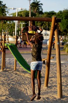 salvador, bahia / brazil - december 1, 2015: Children are seen playing on a playground in the Sao Tome de Paripe neighborhood in the city of Salvador.