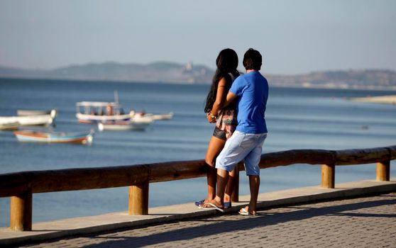 salvador, bahia / brazil - december 2, 2015: couple is seen on Avenida Beira Mar in the Ribeira neighborhood in the city of Salvador.
