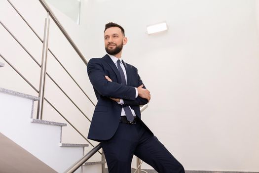 business portrait of a man in an office suit on the landing. Career growth concept.