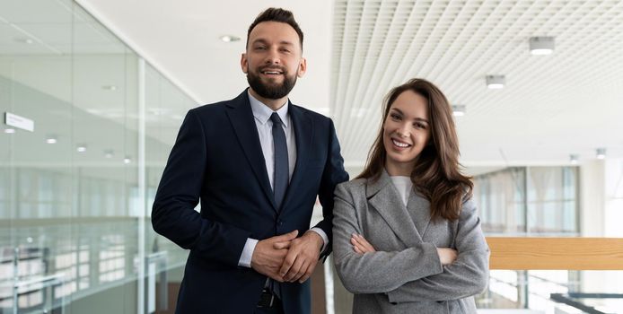 colleagues men and women in business suits on the background of the office space.