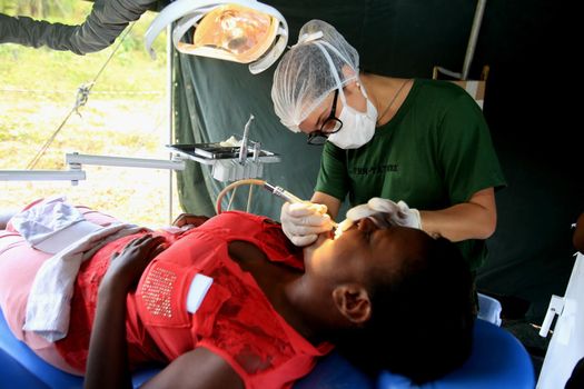 salvador, bahia / brazil - november 4, 2015: dentist from the navy of Brazil is seen during social action on Ilha de Mare in the city of Salvador.




