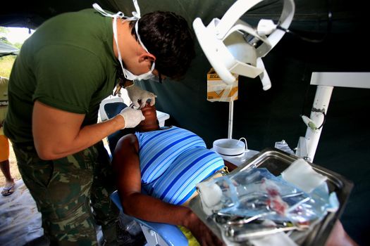 salvador, bahia / brazil - november 4, 2015: dentist from the navy of Brazil is seen during social action on Ilha de Mare in the city of Salvador.




