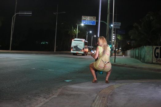 salvador, bahia, brazil - october 5, 2015: Trans woman working as a prostitute on a street in Salvador city.