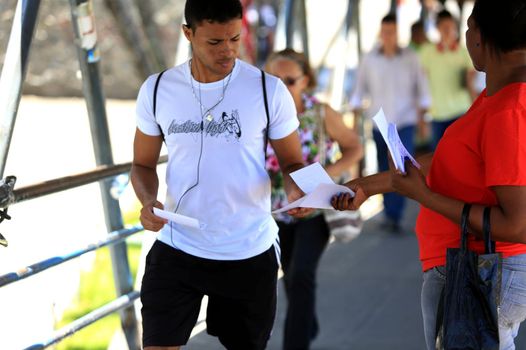 salvador, bahia / brazil - november 12, 2015: person is seen distributing advertising leaflets facing the city of Salvador. The practice is known as leafleting.