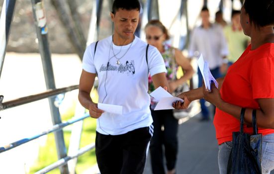 salvador, bahia / brazil - november 12, 2015: person is seen distributing advertising pamphlet in the city of Salvador.



