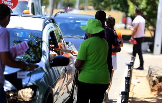 salvador, bahia / brazil - november 12, 2015: person is seen distributing advertising leaflets facing the city of Salvador. The practice is known as leafleting.