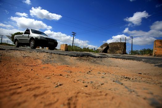 camacari, bahia / brazil - december 7, 2015: Hole in the asphalt is seen on the access road to the Camacari Industrial Pole.