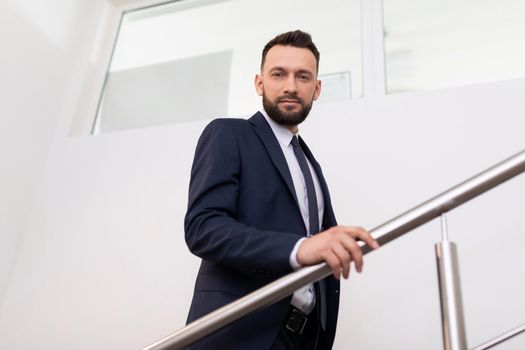 presentable man in a business suit on the landing in the office.
