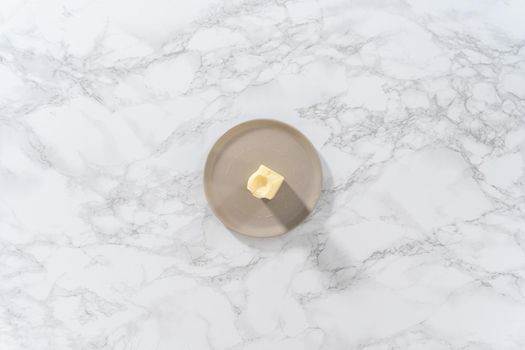 Flat lay. Softened sticks of unsalted butter on in the microwave.