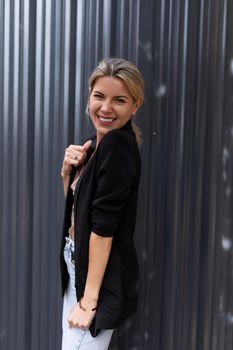 young middle-aged woman in a business suit smiling while looking at the camera.