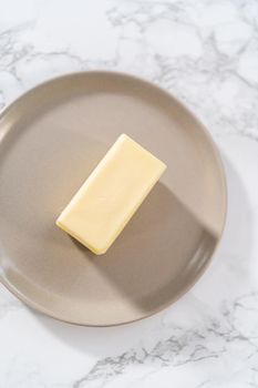 Sticks of unsalted butter on the small plates.