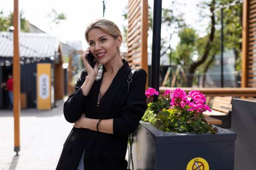 successful young middle-aged woman with a mobile phone and a smile on her face.