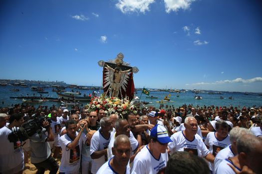 salvador, bahia, brazil - january 1, 2016: image of Bom Jesus dos Navegantes being carried by devotees on Boa Viagem beach after crossing the sea at Baia de Todos os Santos in Salvador.