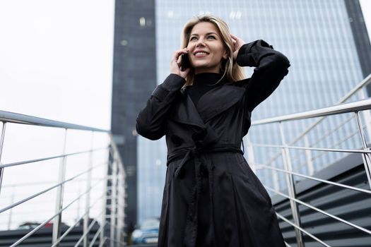 portrait of a successful woman head of a middle-aged businessman against the backdrop of an office skyscraper.