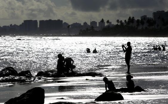 salvador, bahia / brazil - september 6, 2015: People are seen on rocks of Itapua Beach in Salvador.