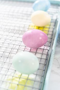 Coloring hard-boiled white eggs with natural food coloring.