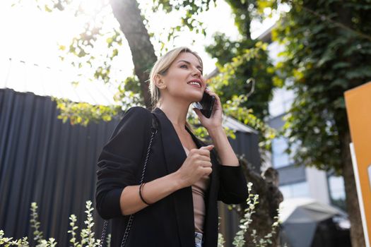 young confident woman talking on mobile phone bottom view.