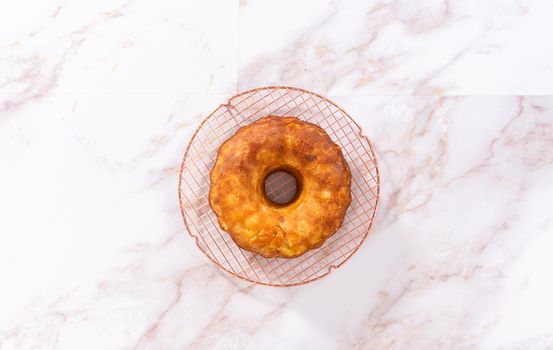 Flat lay. Cooling freshly baked apple bundt cake on a kitchen counter.
