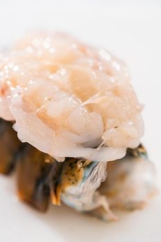 Preparing raw lobster tails to make garlic lobster tails.
