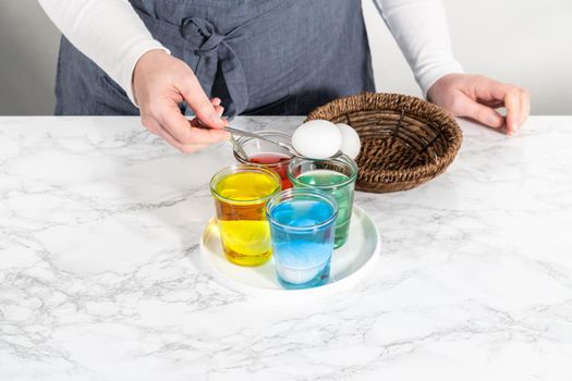 Coloring hard-boiled white eggs with natural food coloring.
