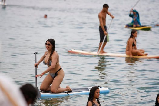 salvador, bahia / brazil - february 21, 2016: People are seen practicing stand up pedal on the beach of Porto da Barra, during the summer of the city of Salvador.