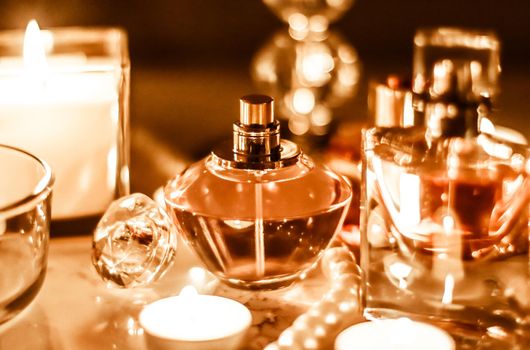 Perfumery, cosmetics branding and luxe concept - Perfume bottle and vintage fragrance on glamour vanity table at night, pearls jewellery and eau de parfum as holiday gift, luxury beauty brand present