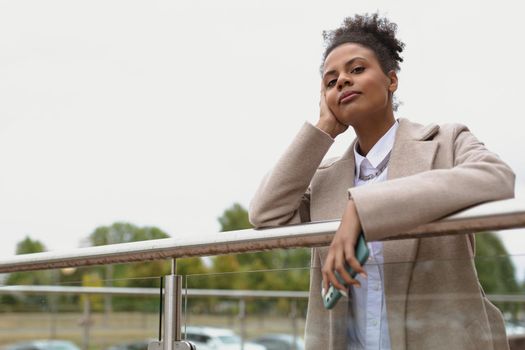 portrait of a serious pensive black young woman looking longingly into the distance.