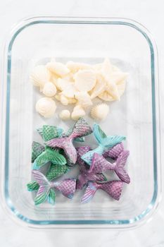 Chocolate seashells and mermaid tails in a glass container.