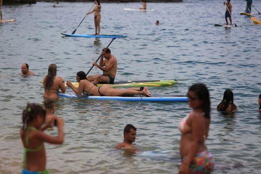 salvador, bahia / brazil - february 21, 2016: People are seen practicing stand up pedal on the beach of Porto da Barra, during the summer of the city of Salvador.