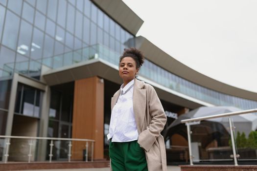portrait of a seriously successful business african american woman in front of an office building, bottom view.