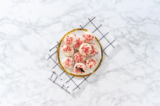 Flat lay. Freshly baked peppermint white chocolate cookies on a white plate.