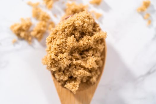 Light brown sugar on a marble counter top.