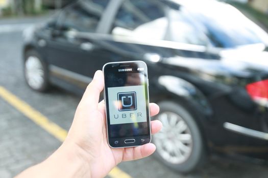 salvador, bahia / brazil - june 21, 2016: Uber driver application, passenger transport is seen in the city of Salvador.