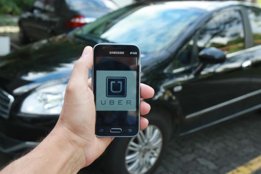 salvador, bahia / brazil - june 21, 2016: Uber driver application, passenger transport is seen in the city of Salvador.