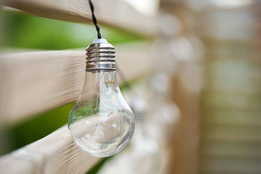 Close up picture of LED sun powered bulb on the wooden wall