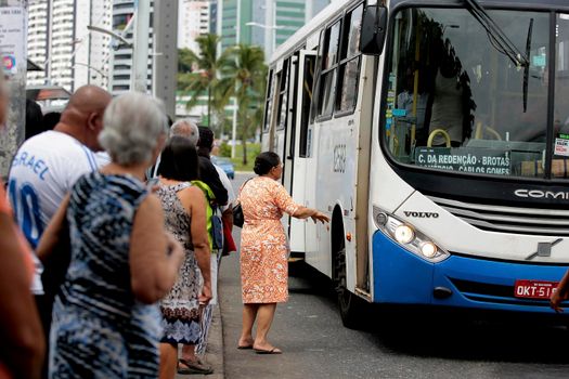 salvador, bahia / brazil - september 22, 2016: Senior citizen is seen waiting for public transportation bus from Salvador city.