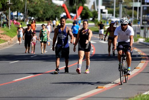 Salvador, Bahia / Brazil - August 7, 2016: People seen practicing physical activity on Avenida Magalhaes Neto in Salvador during leisure streets project.