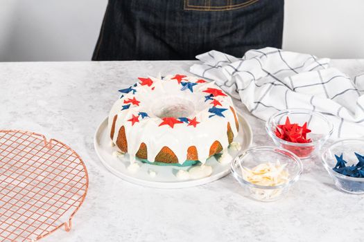 Decorating freshly baked bundt cake with chocolate stars for the July 4th celebration.