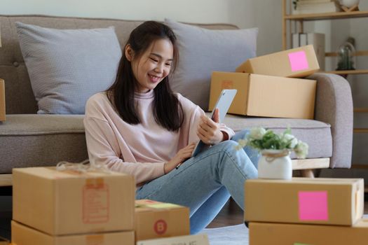 Asian SME business woman working at home office. online shopping concept.