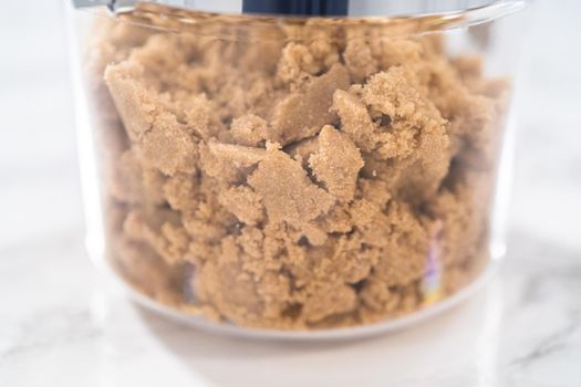 Light brown sugar on a marble counter top.