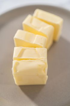 Softened sticks of unsalted butter on the kitchen counter.