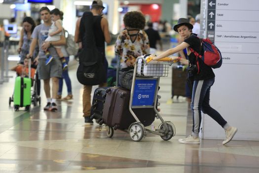 salvador, bahia, brazil - march 10, 2017: Passenger carrying luggage in the departure area of the airport in the city of Salvador.