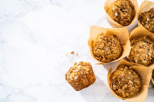 Freshly baked banana oatmeal muffins with oatmeal sugar topping.