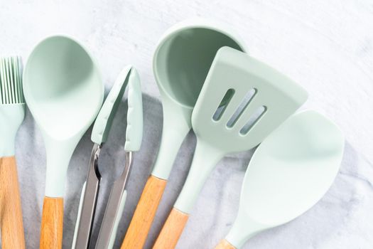 Silicone cooking utensils with wooden handle.