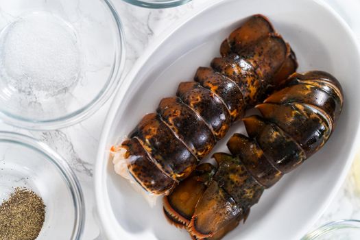 Flat lay. Measured ingredients in glass mixing bowls to prepare garlic lobster tails.